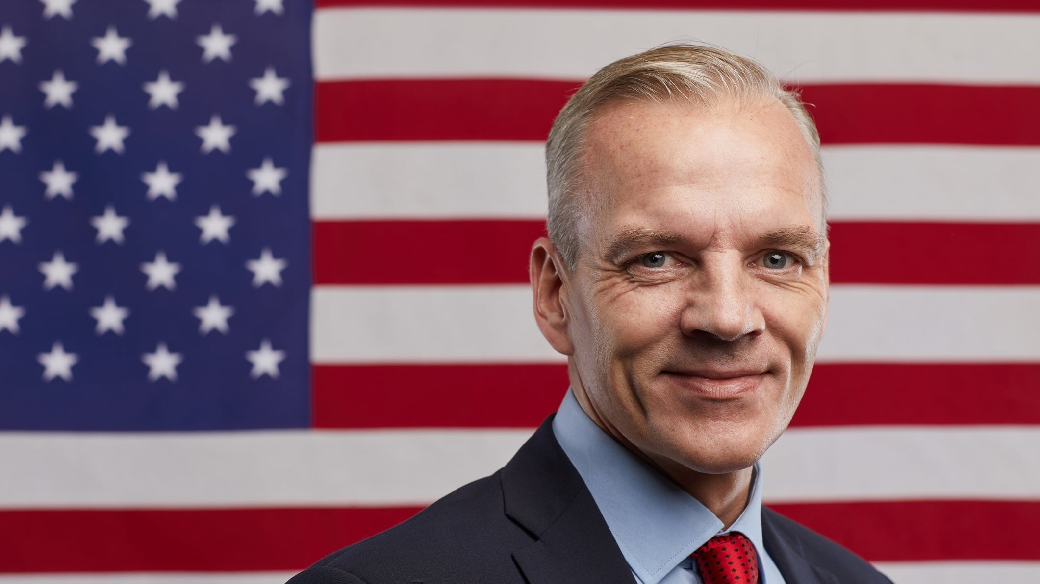 Businessman posing in front of US flag
